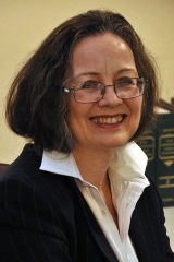 Headshot of Maureen L. Tucker in white-collared shirt and black blazer